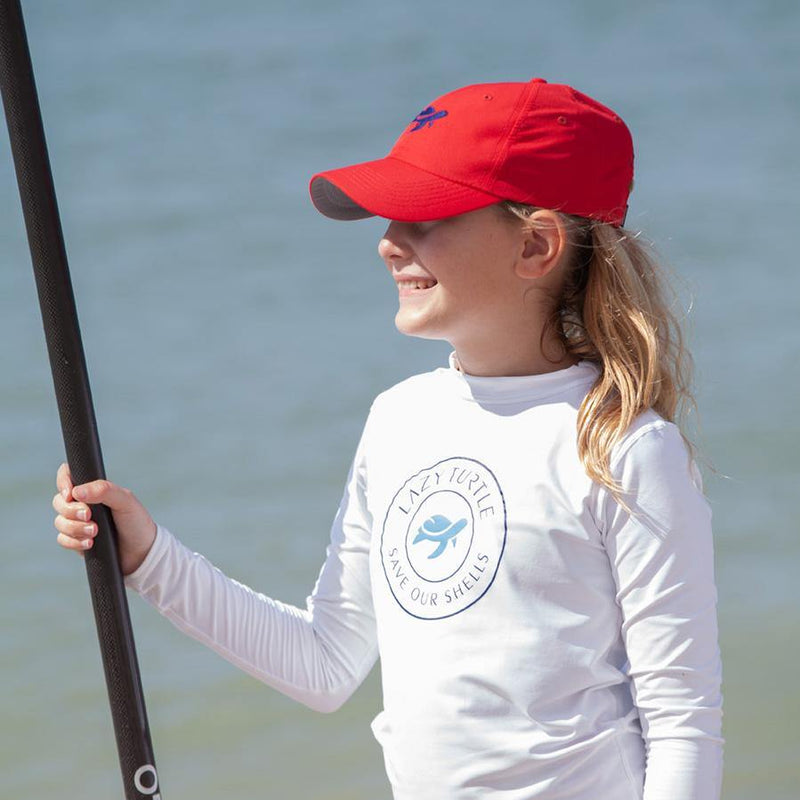 Side view of girl wearing Turtle Classic Kids on paddleboard
