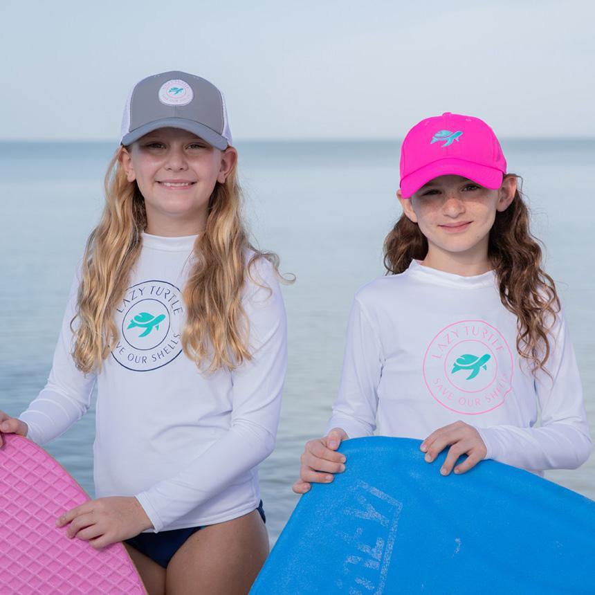 Two girls wearing Paddle Sun Safe Long Sleeve on beach