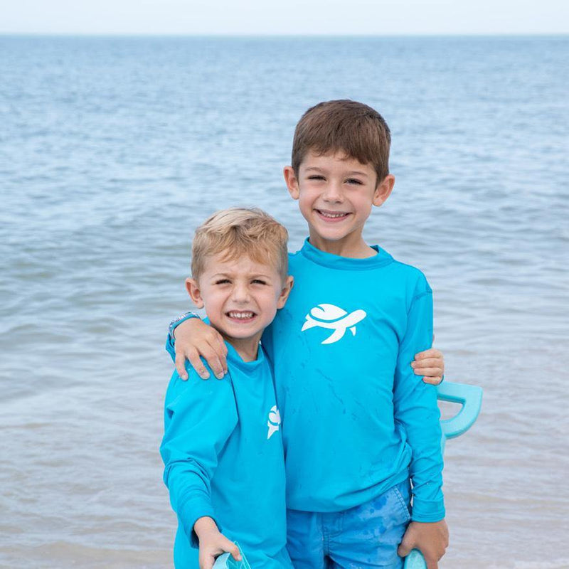 Two boys wearing Sand Castle Sun Safe Long Sleeve on beach